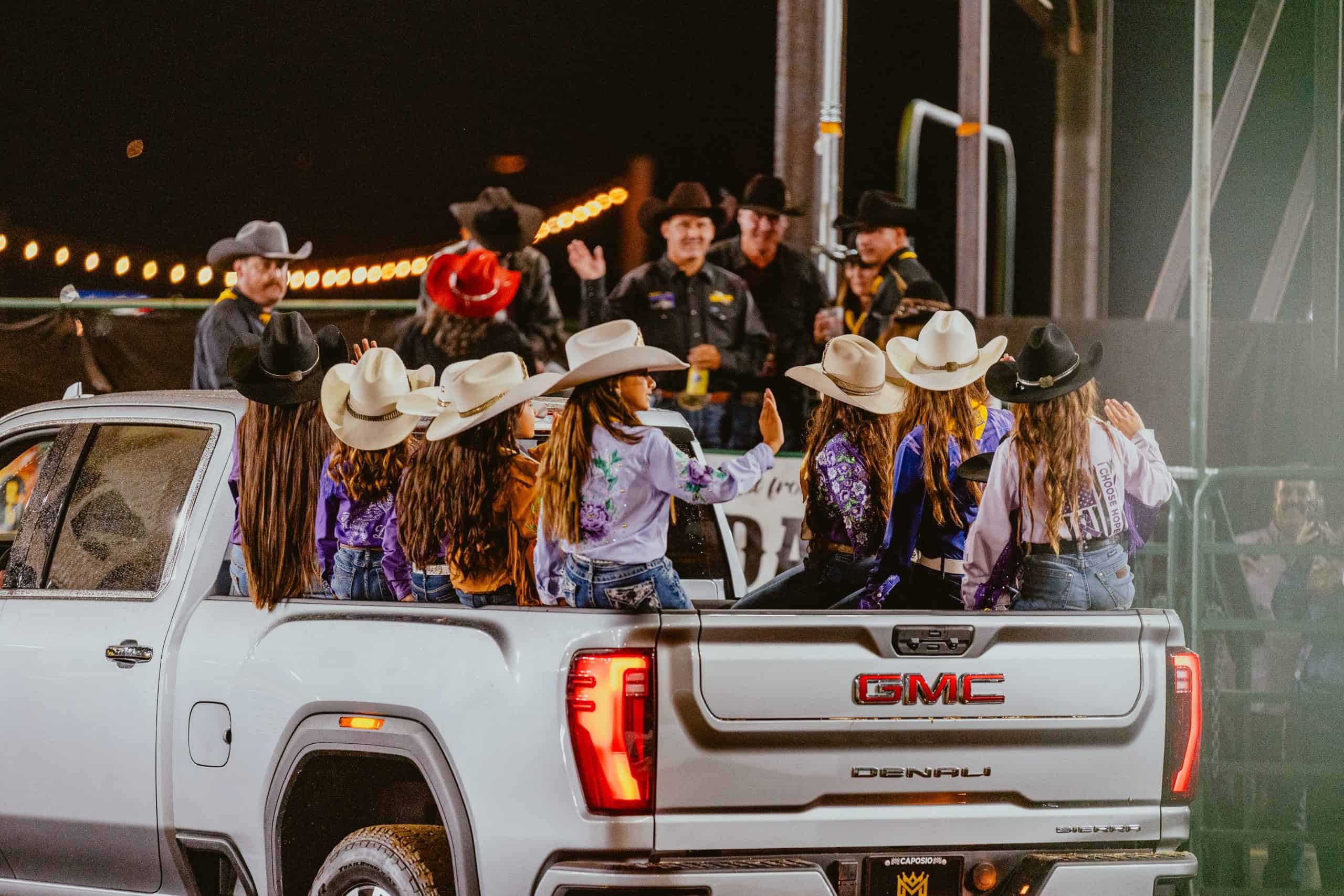 Men and women in the back of the truck for the closing ceremony of the event, live streaming internet provided by PopUp WiFi.