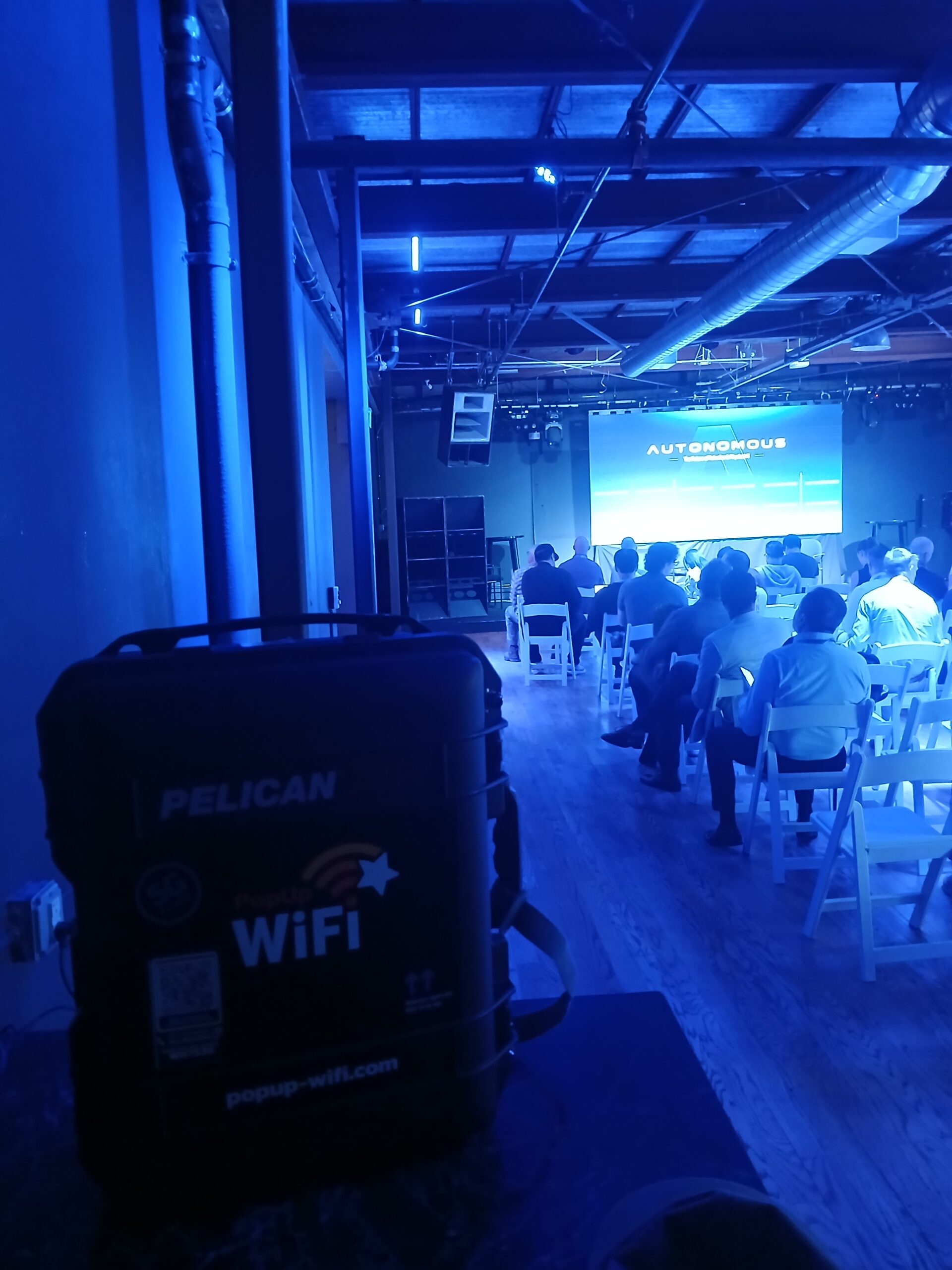 PopUp WiFi Pelican Air rugged case with 5G and PopUp WiFi branding set up backstage at the AUTONOMOUS 2026 conference venue