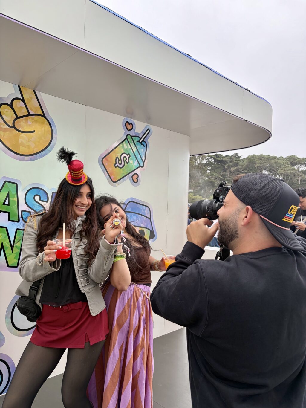 PopUp WiFi at a festival in San Francisco with a photographer shooting two fans in front of a brand activation.