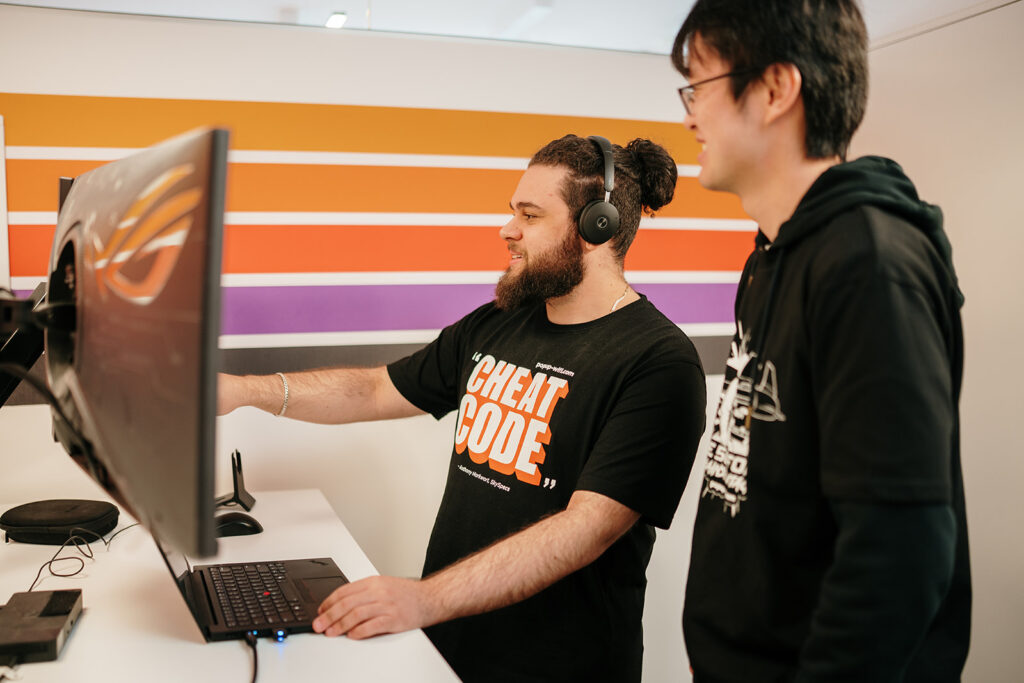 PopUp WiFi's expert Peplink Network Engineers in front of their computers manning 24/7 support phone and text support