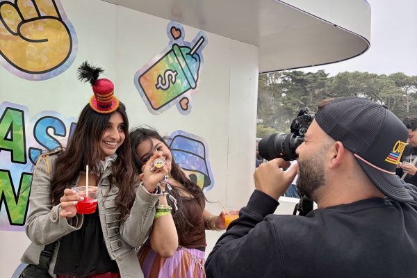 PopUp WiFi at a festival in San Francisco with a photographer shooting two fans in front of a brand activation.